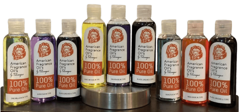 Bottles of American Fragrance Oil in various scents on a metal surface.